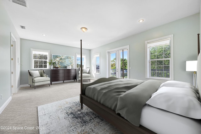 carpeted bedroom featuring french doors and access to outside