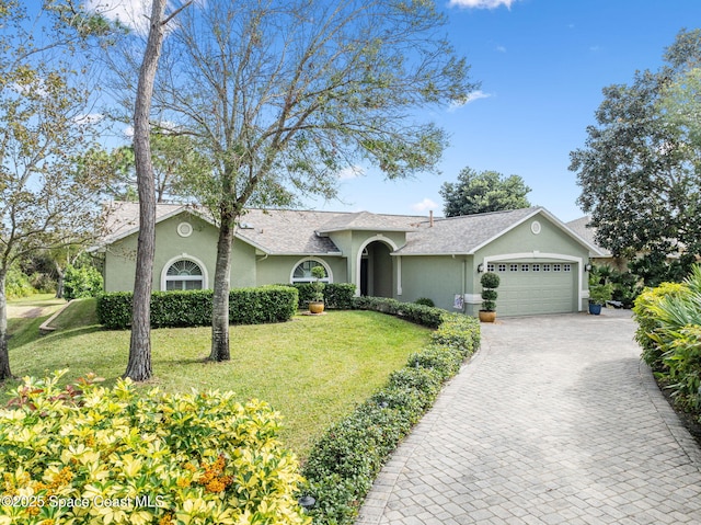 ranch-style home featuring a front yard and a garage