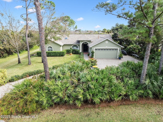 ranch-style home featuring a garage and a front yard