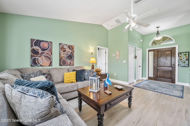 living room with hardwood / wood-style floors, vaulted ceiling, and ceiling fan