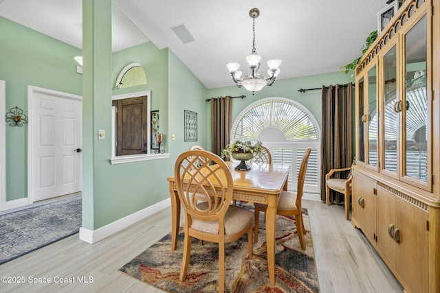 dining area featuring a chandelier and light wood-type flooring