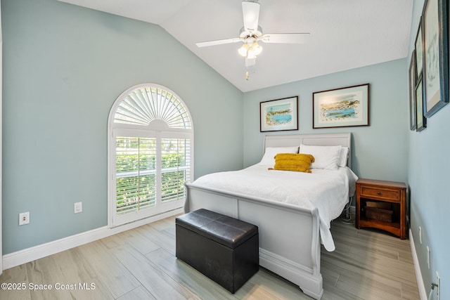 bedroom featuring light wood-type flooring, ceiling fan, and lofted ceiling