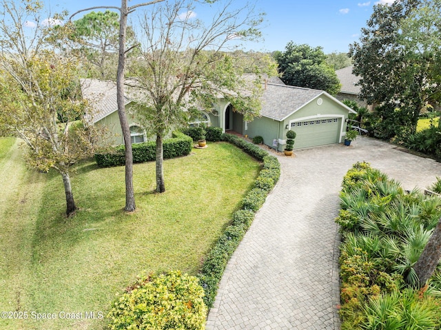 view of front of home featuring a front lawn and a garage