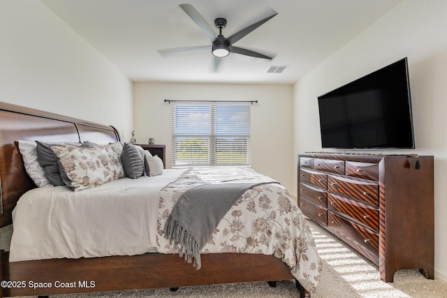 carpeted bedroom featuring ceiling fan and visible vents