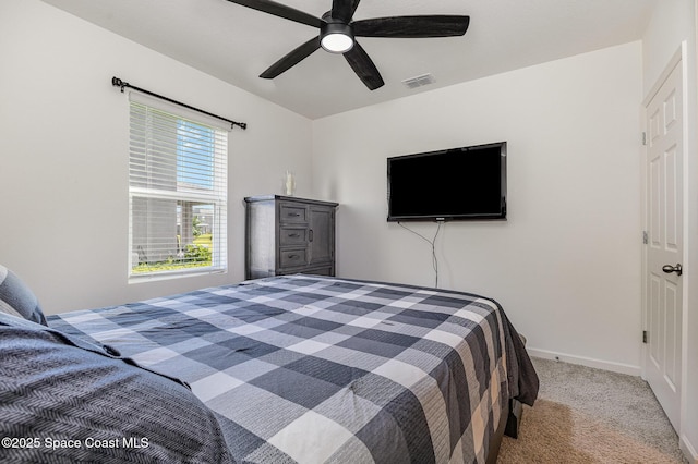 carpeted bedroom with baseboards, visible vents, and a ceiling fan