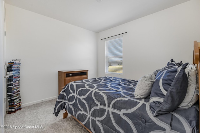 bedroom featuring carpet floors and baseboards