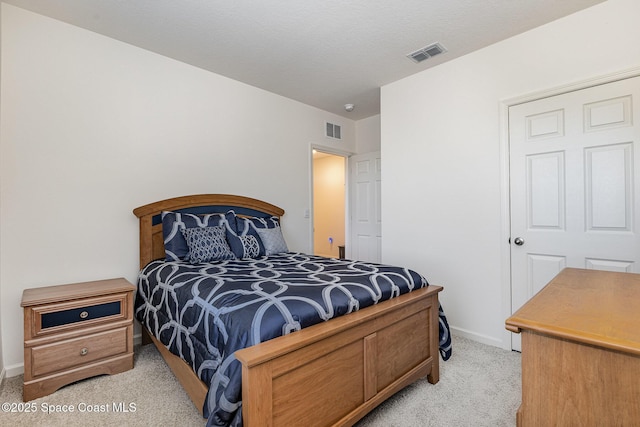 bedroom featuring light colored carpet, visible vents, and baseboards