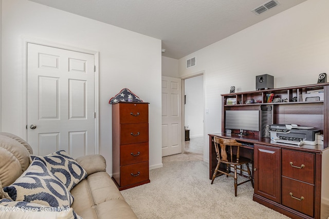 office space featuring light colored carpet, visible vents, and baseboards