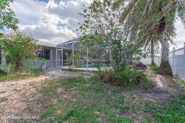 view of yard with a fenced in pool and a lanai