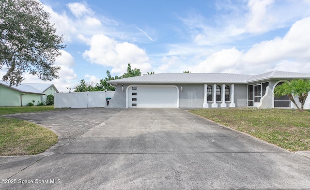 single story home featuring a garage and a front yard