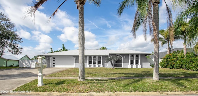 single story home featuring a garage and a front yard