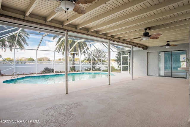 view of pool with ceiling fan, a lanai, and a patio