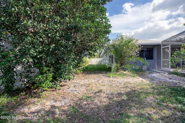 view of yard with a lanai