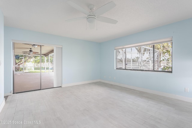 unfurnished room featuring ceiling fan and a textured ceiling