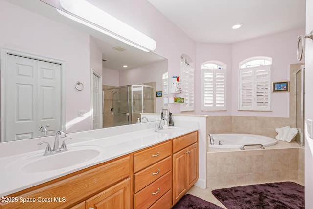 bathroom with tile patterned floors, vanity, and independent shower and bath