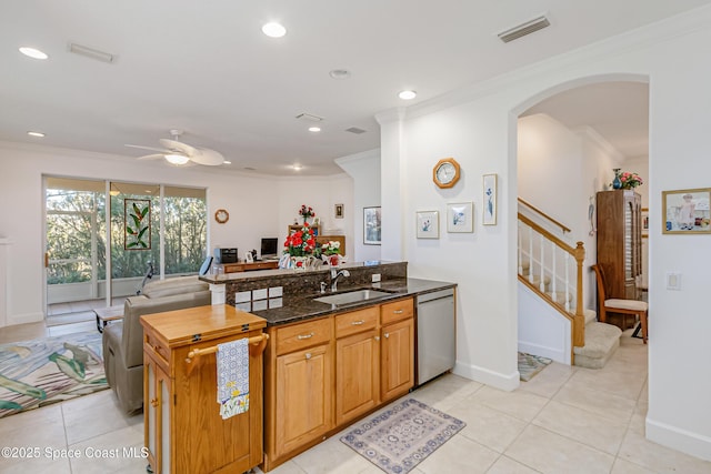 kitchen featuring ceiling fan, dishwasher, sink, dark stone countertops, and ornamental molding