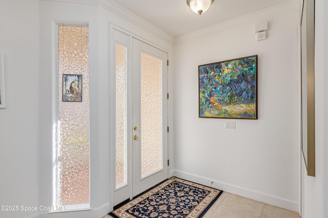 tiled entryway featuring crown molding