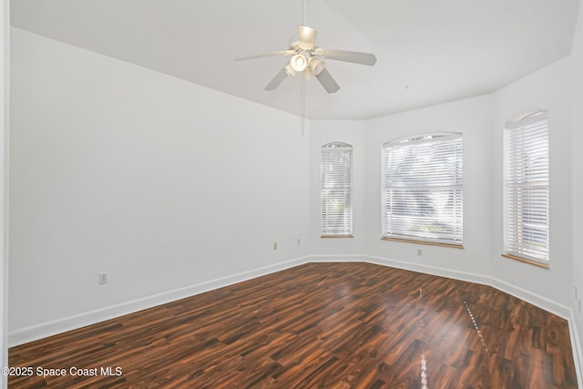 unfurnished room with dark hardwood / wood-style flooring and ceiling fan