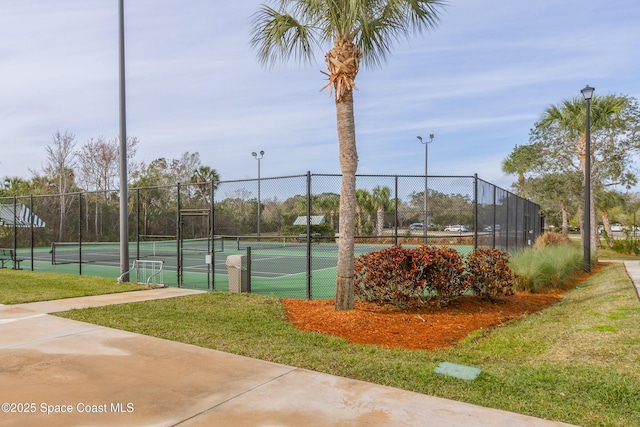 view of tennis court with a lawn