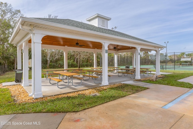 view of community featuring a gazebo, tennis court, and a patio