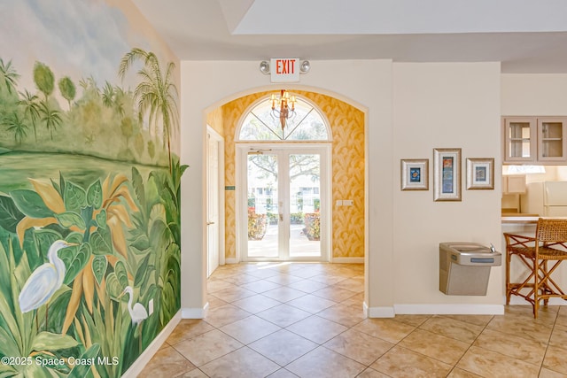 foyer entrance featuring light tile patterned floors and french doors