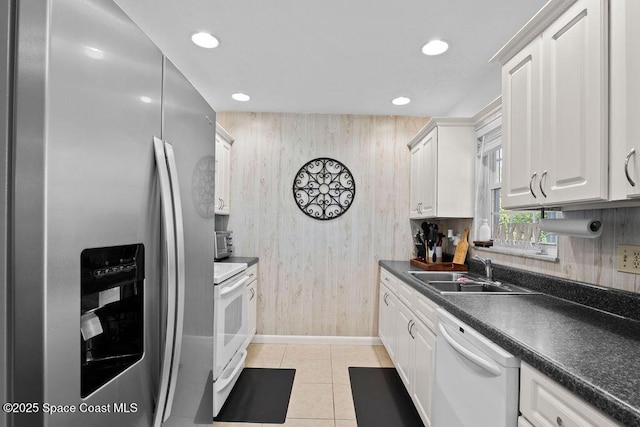 kitchen featuring dishwasher, light tile patterned floors, stainless steel refrigerator with ice dispenser, stove, and white cabinets