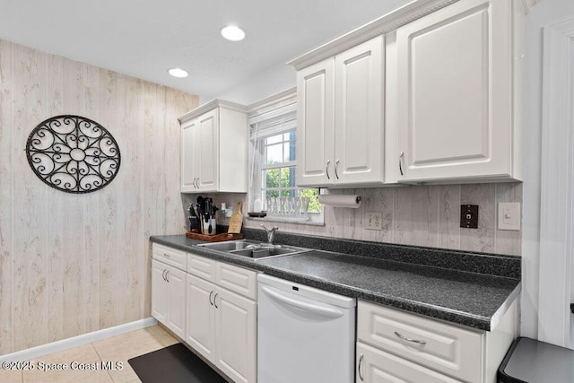 kitchen with white cabinetry, sink, white dishwasher, and light tile patterned floors