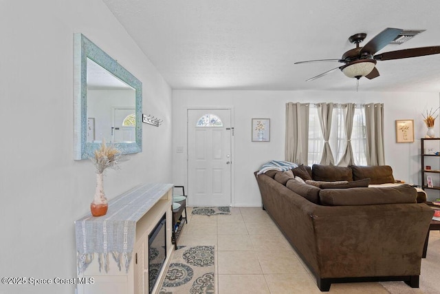 living room featuring ceiling fan and light tile patterned flooring