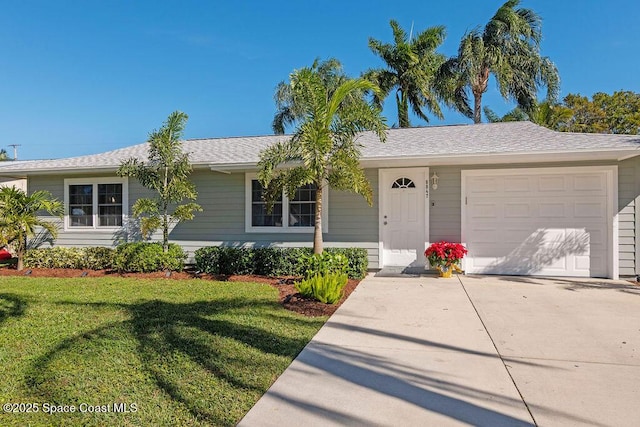 single story home featuring a garage and a front lawn