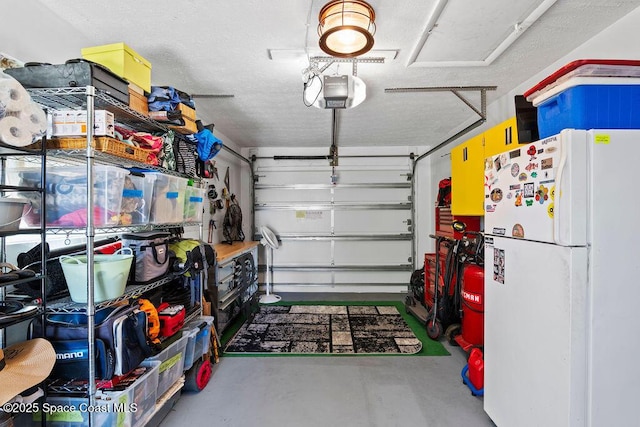 garage with white fridge and a garage door opener