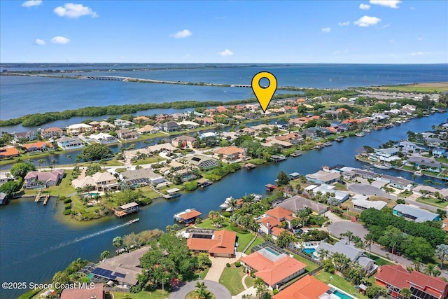 drone / aerial view featuring a water view and a residential view