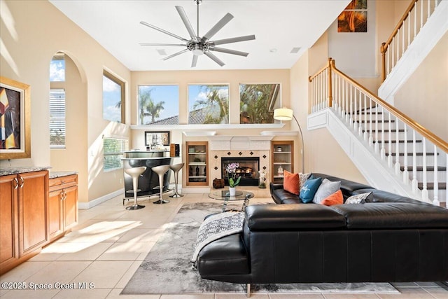 living room featuring ceiling fan and light tile patterned floors