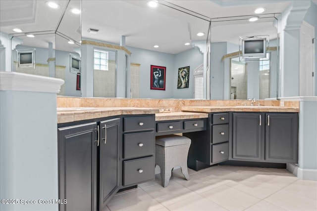 full bathroom featuring double vanity, a stall shower, tile patterned flooring, a sink, and recessed lighting