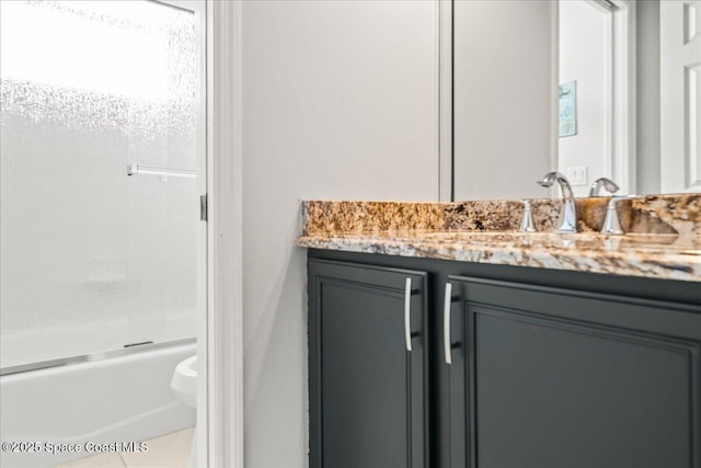 full bath featuring  shower combination, tile patterned floors, toilet, and vanity