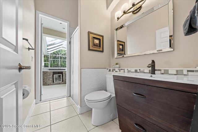 bathroom with vanity, toilet, and tile patterned floors