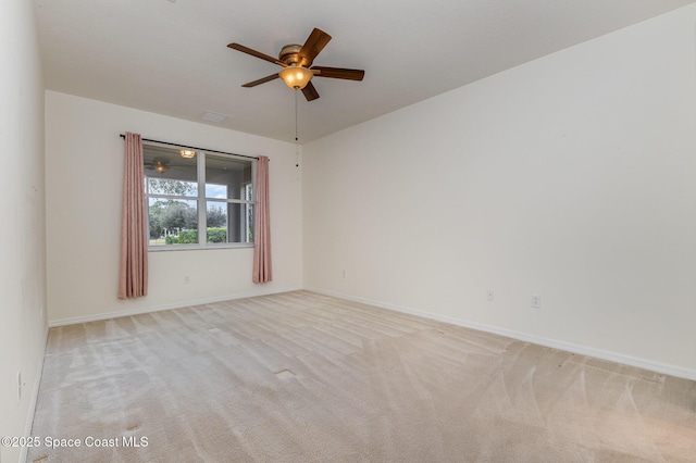 empty room with ceiling fan and light colored carpet