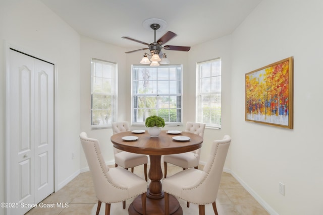 tiled dining area with ceiling fan