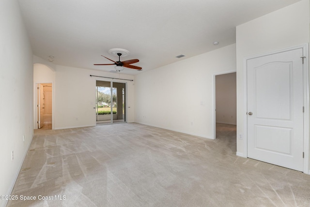 carpeted empty room featuring ceiling fan