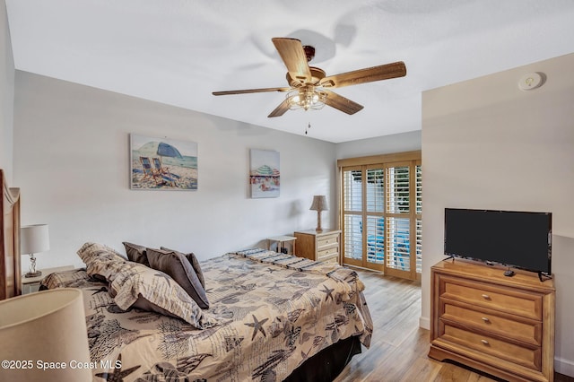 bedroom with light hardwood / wood-style floors and ceiling fan