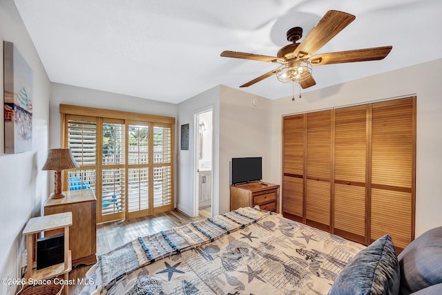 bedroom with ceiling fan, a closet, ensuite bathroom, and light hardwood / wood-style floors