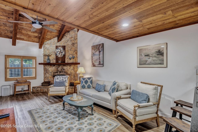 living room with hardwood / wood-style floors, wooden ceiling, vaulted ceiling with beams, ceiling fan, and a fireplace