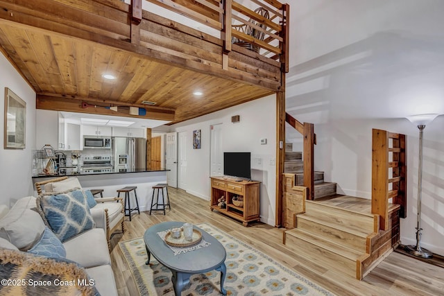 living room with light hardwood / wood-style flooring and wood ceiling