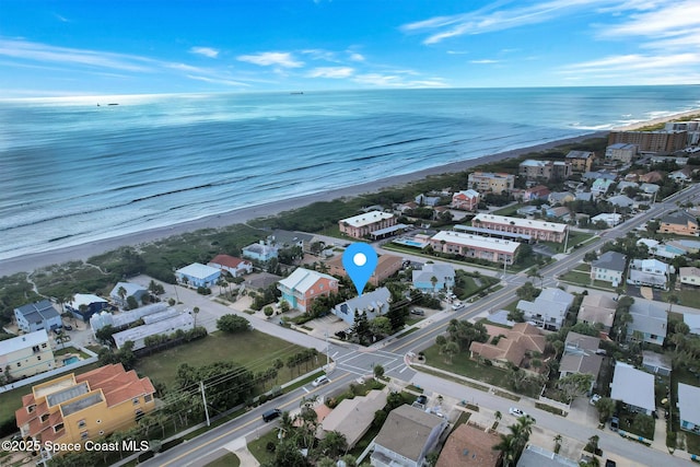 drone / aerial view with a water view and a beach view