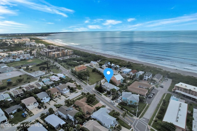 drone / aerial view featuring a water view and a view of the beach