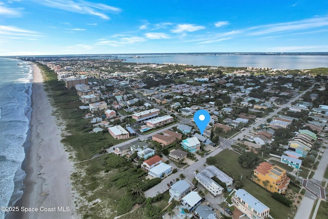 drone / aerial view featuring a view of the beach and a water view