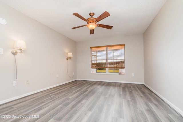 spare room featuring ceiling fan, a textured ceiling, and light hardwood / wood-style flooring