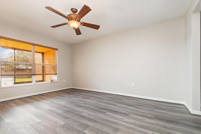 unfurnished room with ceiling fan, hardwood / wood-style floors, and a textured ceiling