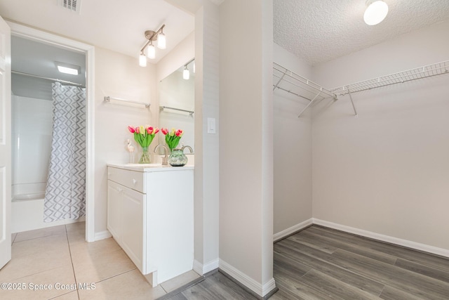 walk in closet featuring sink and hardwood / wood-style floors