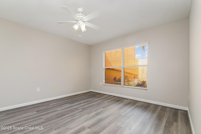 unfurnished room with hardwood / wood-style floors and ceiling fan