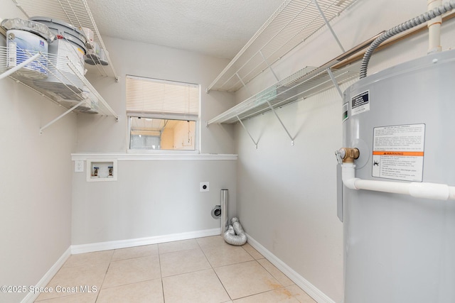 clothes washing area featuring washer hookup, light tile patterned floors, a textured ceiling, and electric dryer hookup